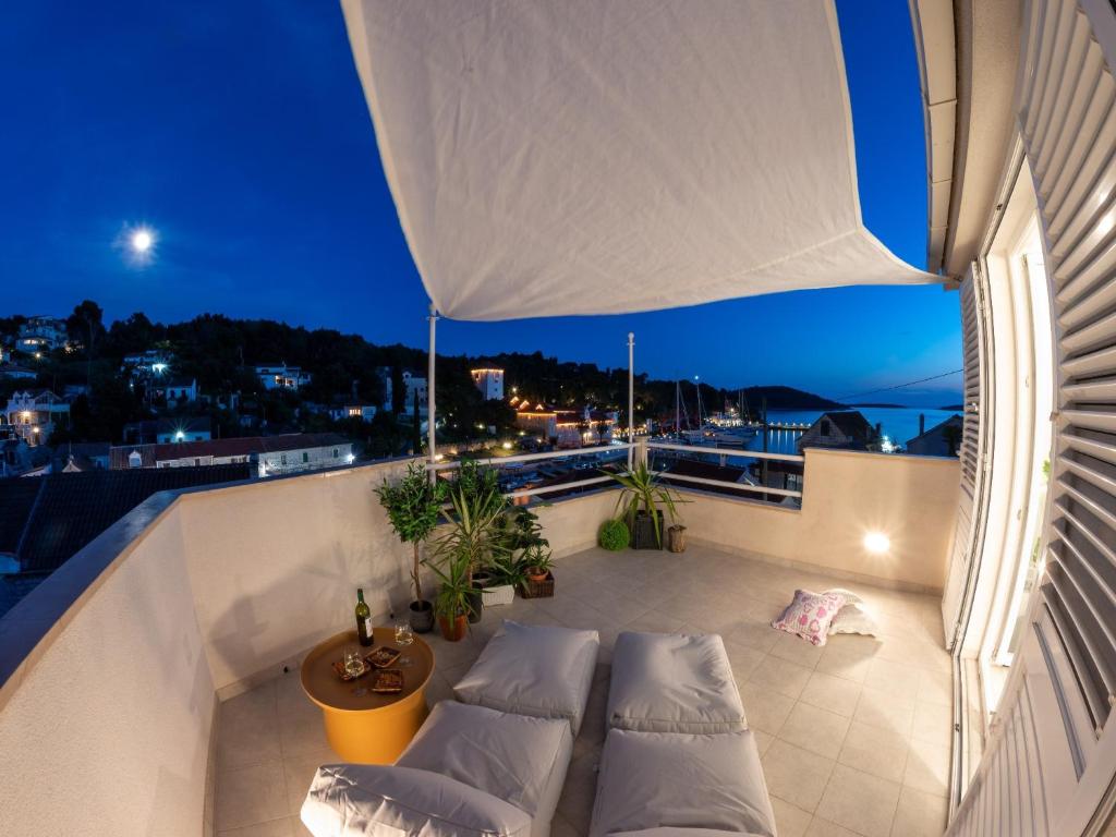 a balcony with couches and a view of the city at Holiday Home Lea in Maslinica