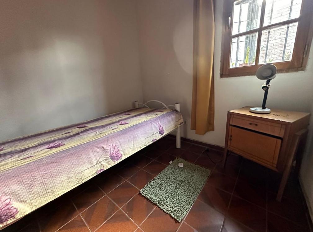 a bedroom with a bed and a dresser and a window at Habitacion INDIVIDUAL en casa compartida- cama individual in Villa Marini