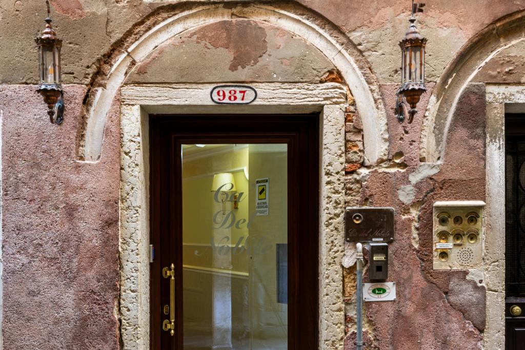 a door to a building with a sign on it at Ca' Del Nobile in Venice