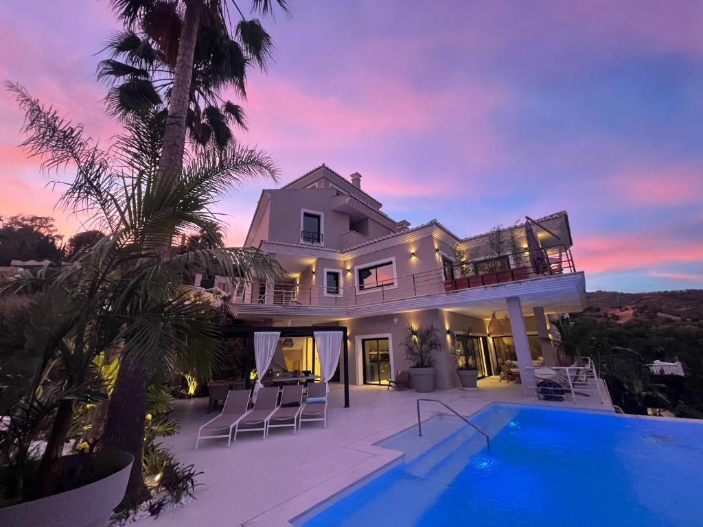 a villa with a swimming pool and a sunset at NEW LUXURY VILLA : 7 BEDROOMS : POOL : GYM : SPA in Marbella