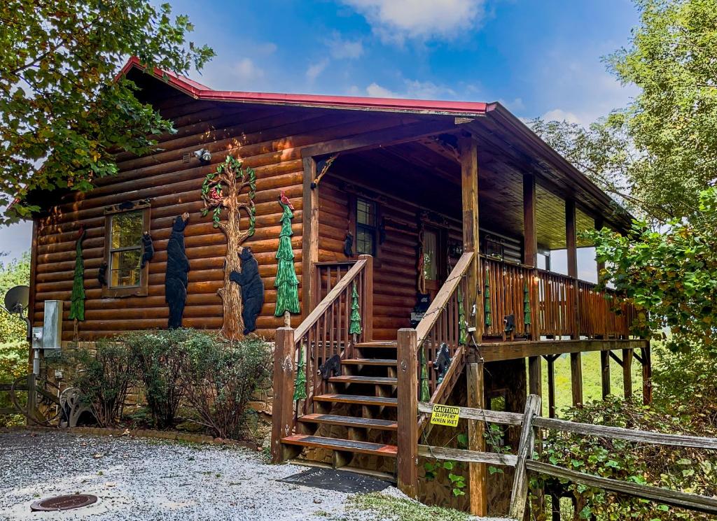 a log cabin with a staircase leading up to it at Rustic Cabin, Fire Pit with HotTub, Mountain Views, Peaceful Location in Sevierville