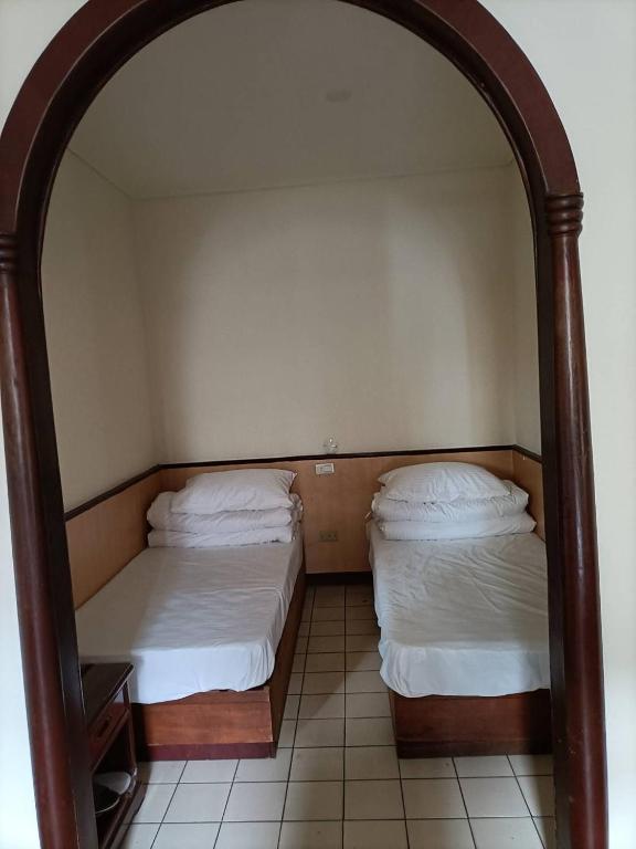 Postel nebo postele na pokoji v ubytování 丸松商旅