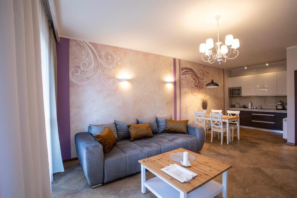 a living room with a couch and a table at Apartamenty Home Sweet Home in Szklarska Poręba