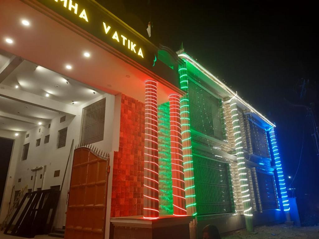 a building with colorful lights on the side of it at Purna Brahma Vatika in Deoghar