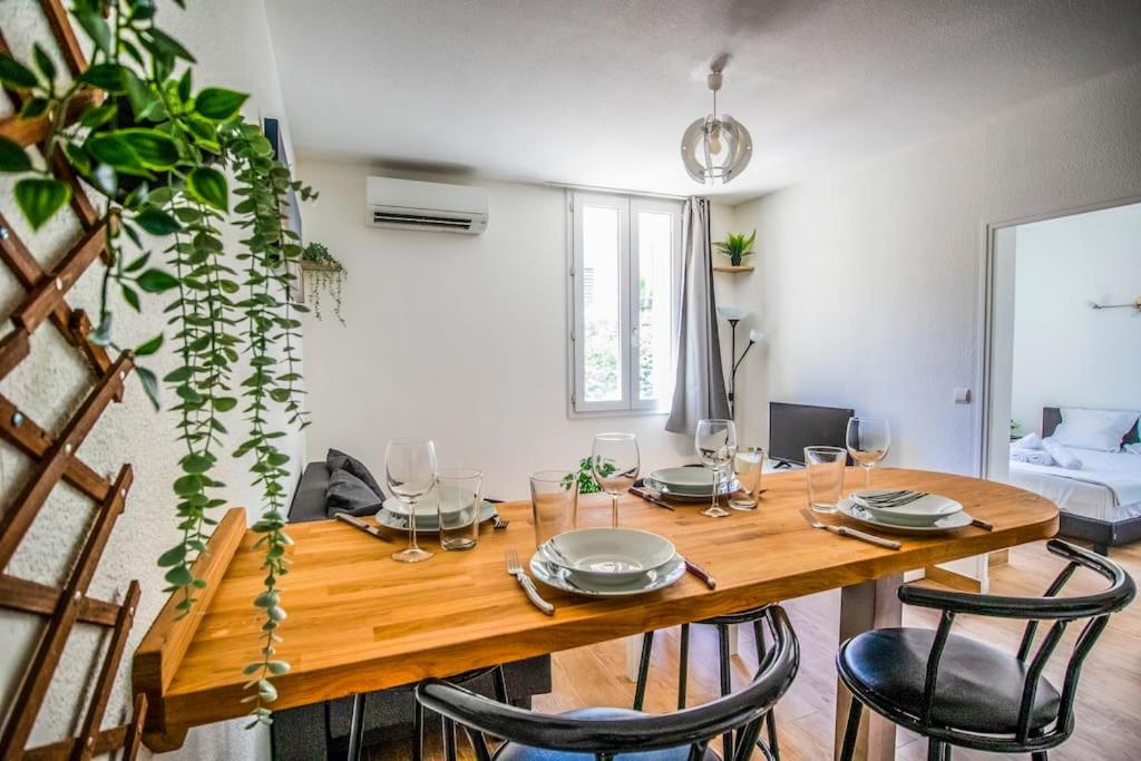 a wooden table in a room with chairs and a dining room at 21 Centre Historique - Gare- Place de la Comédie in Montpellier