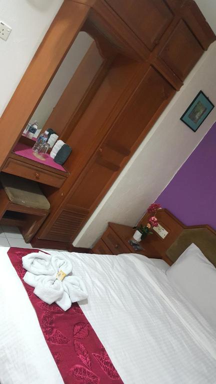 Postel nebo postele na pokoji v ubytování New Orchid Hotel Tuaran