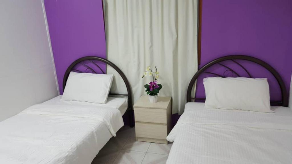 Postel nebo postele na pokoji v ubytování New Orchid Hotel Tuaran