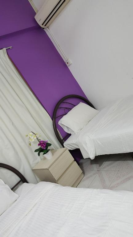 Postel nebo postele na pokoji v ubytování New Orchid Hotel Tuaran