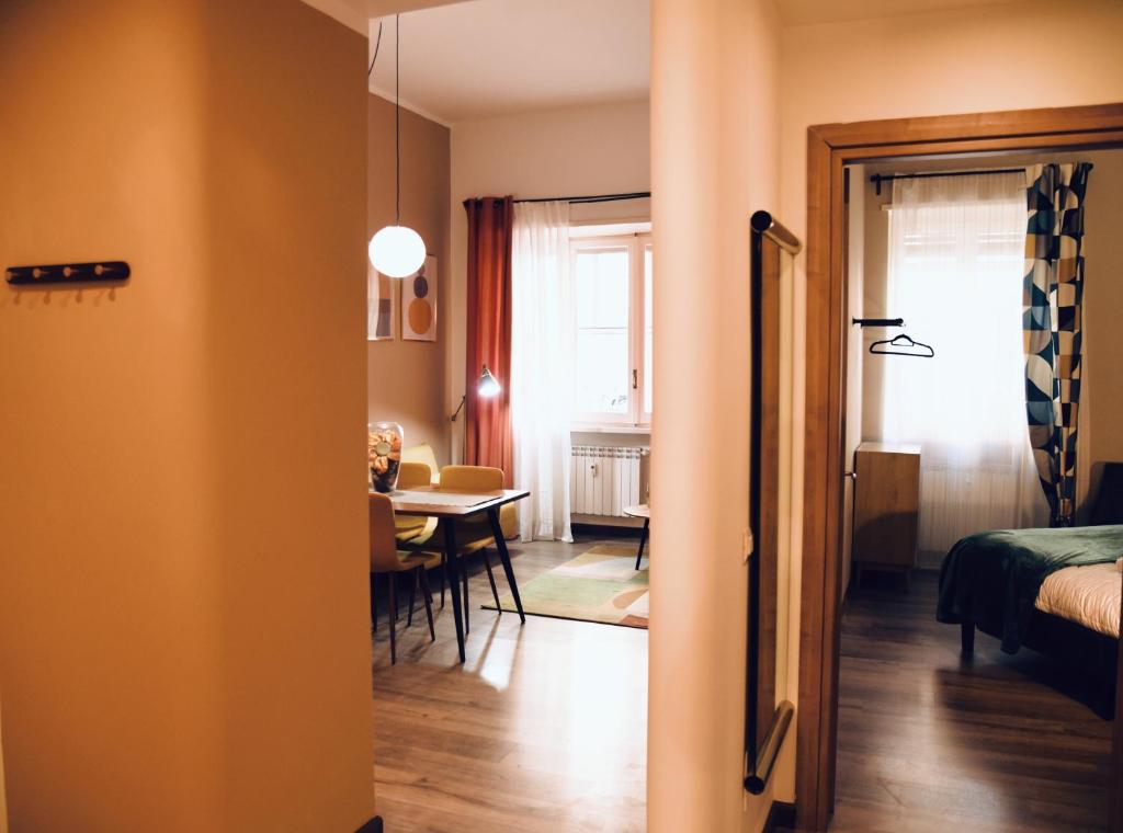 a room with a bed and a dining room with a table at Cozy and Elegant Apartment in Rome in Rome