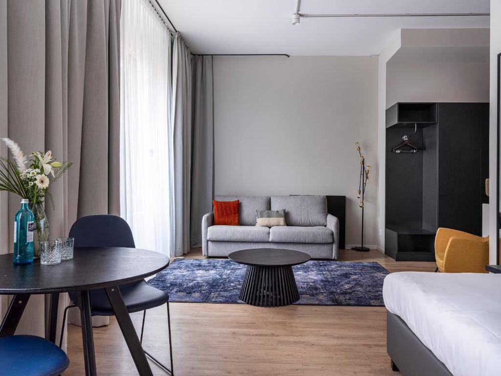 a living room with a bed and a table at Numa Frankfurt Bloc in Frankfurt