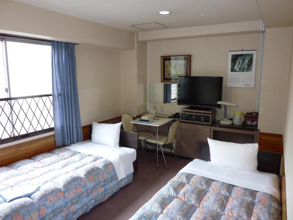 Cama o camas de una habitación en Otsuka City Hotel