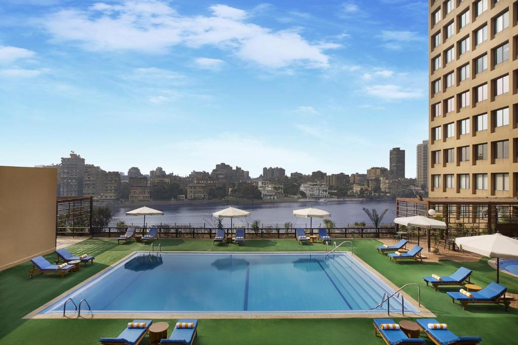 a large swimming pool on the roof of a building at Cairo World Trade Center Hotel & Residences in Cairo