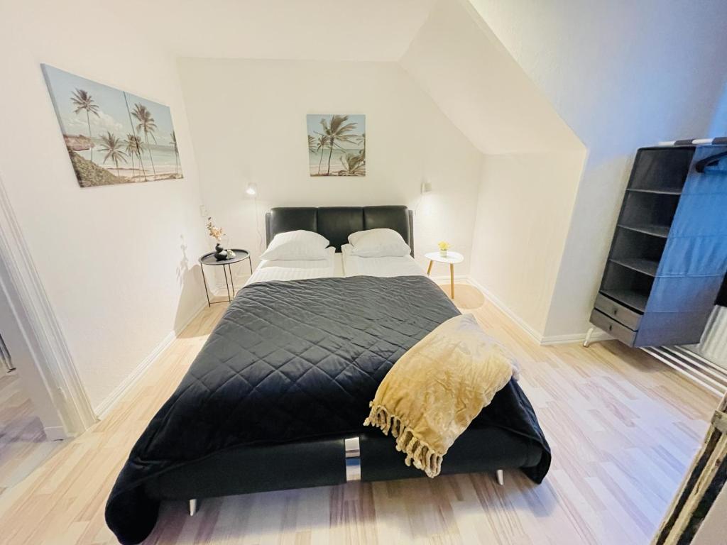 a bedroom with a large black bed in a room at aday - Randers Elegant and Trendy Apartment in Randers