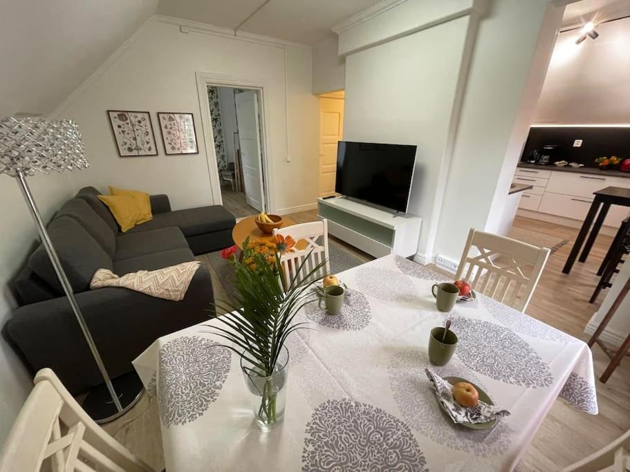 a living room with a table and a couch at Satavuotias helmi Mäntässä in Mänttä