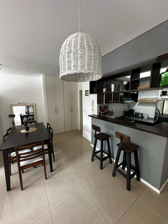 a kitchen with a table and chairs and a dining room at Lovely & Lightful Studio with pool in San Fernando