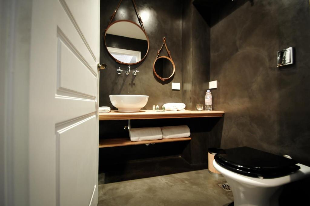 a bathroom with a sink and a toilet and a mirror at Hotel Clasico in Buenos Aires