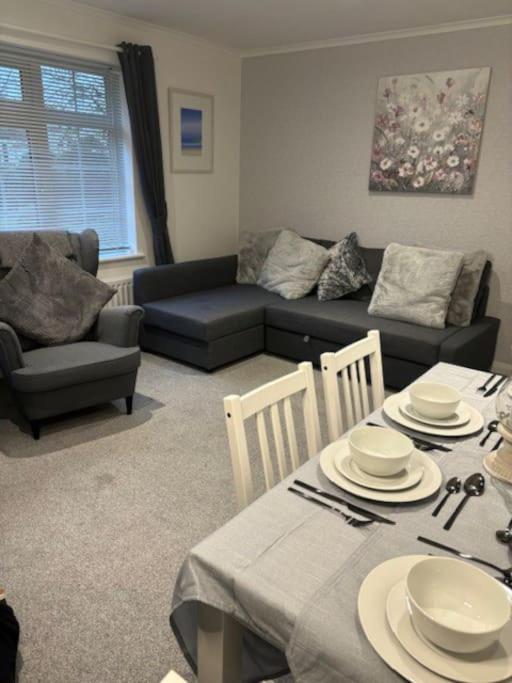 a living room with a table and a couch at Clarke's AirBnB in Worthing