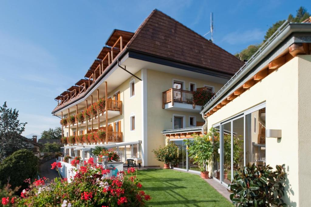 an exterior view of a building with a yard at Hotel Haus an der Luck in Barbiano