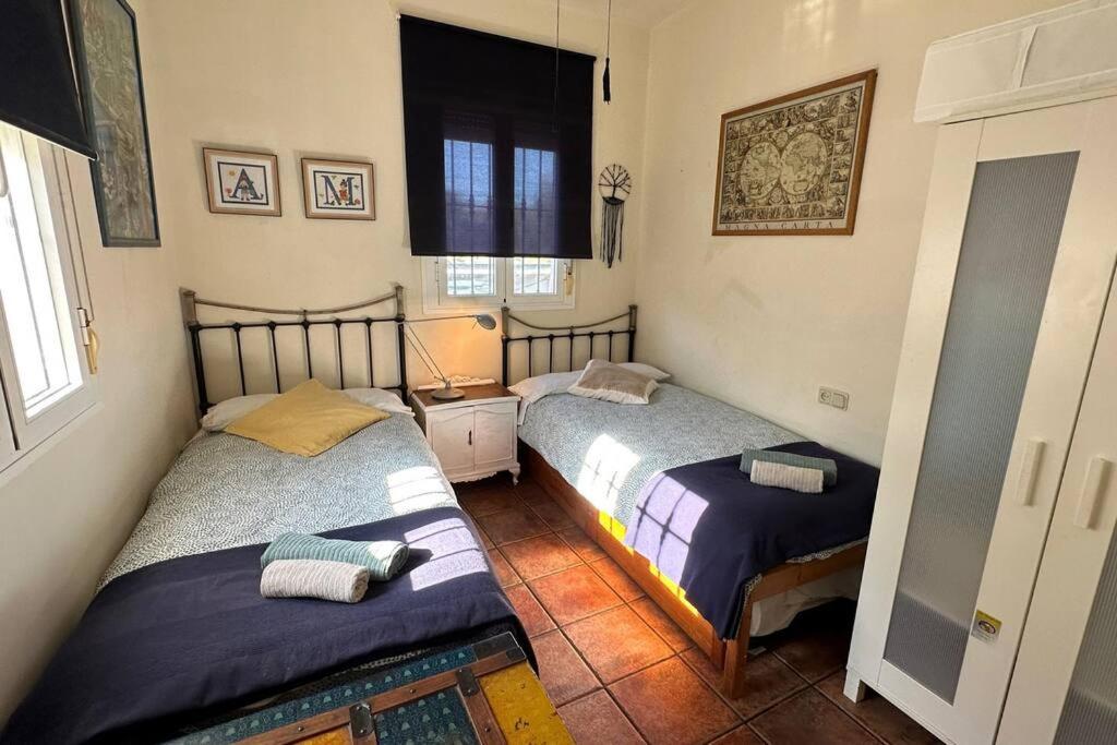 a bedroom with two beds in a room at Casa rural de encanto en plena Serranía de Ronda in Ronda