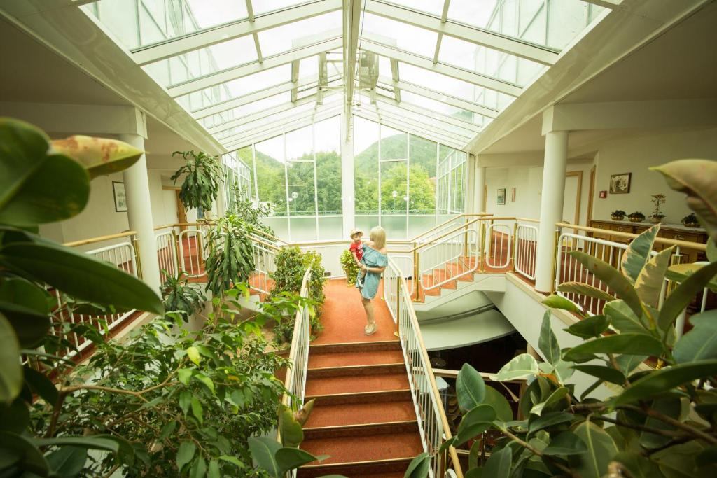 two children walking down the stairs in a greenhouse at Garni Hotel Danja Herold e. U. in Maria Lankowitz