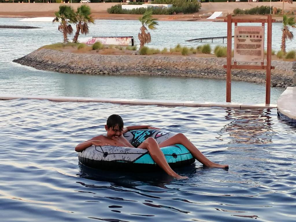 a man is laying on an inflatable at El Gouna Lagoon Paradise Penthouse in Hurghada