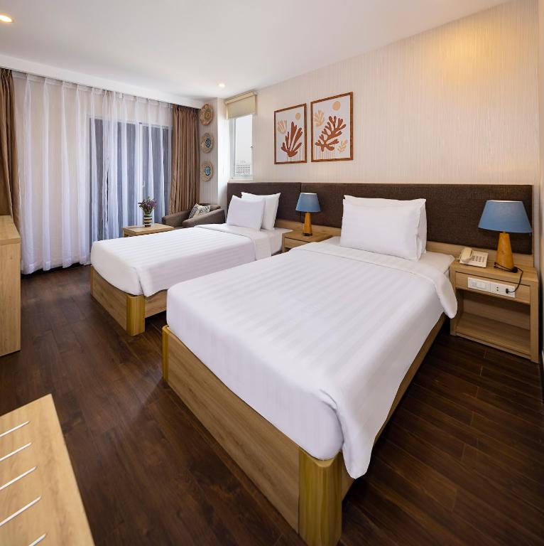 Postel nebo postele na pokoji v ubytování DB Hotel Nha Trang