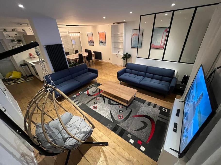 a living room with blue couches and a flat screen tv at C - Maison 10 min PARIS EXPO - 5 rooms/5 beds in Arcueil