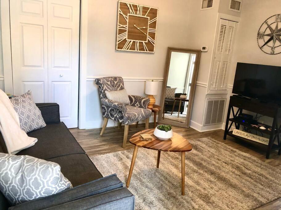 a living room with a couch and a table at In the Heart of Downtown Dunedin One Bedroom Apt NO KIDS, NO PETS in Dunedin