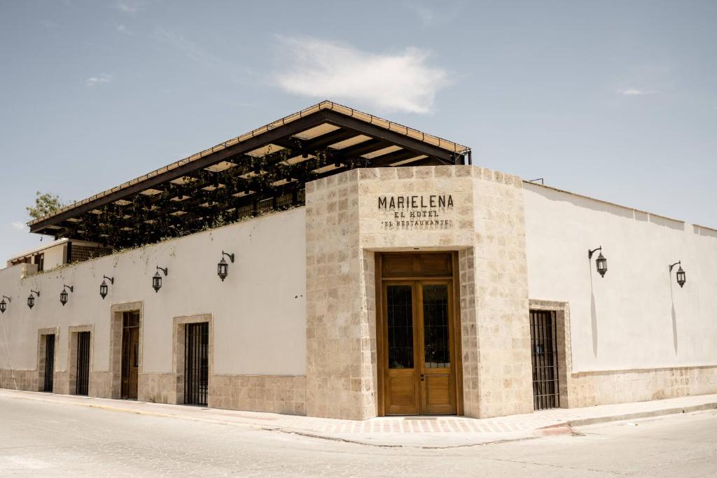 a building with a sign on the front of it at Hotel Marielena in Cuatrociénegas de Carranza