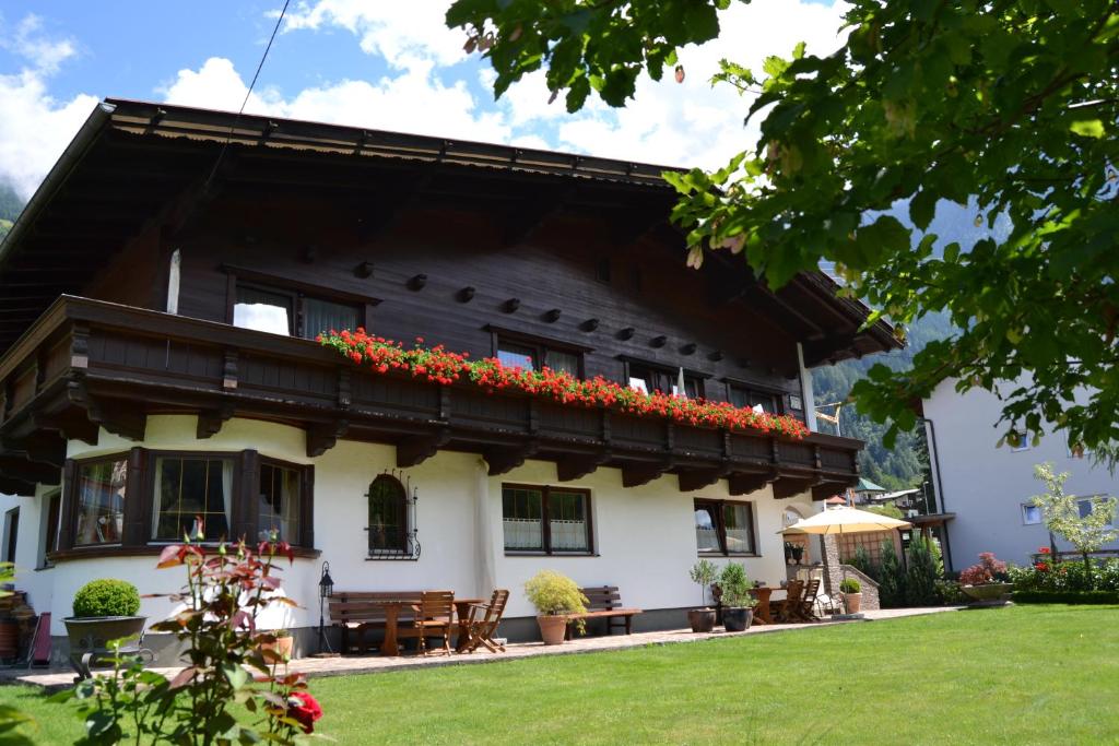 a house with a balcony with flowers on it at Appartements Falkner Dorli in Oetz