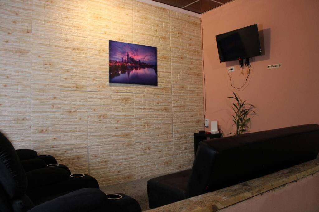 a waiting room with chairs and a flat screen tv at Casa LUNA in Boquete