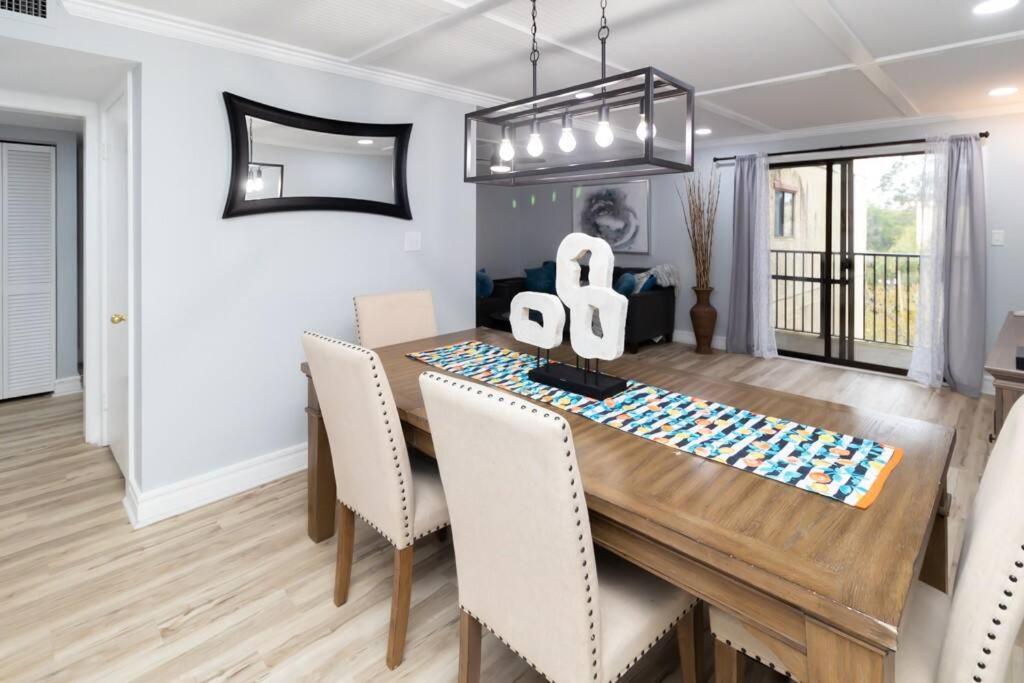 a dining room with a wooden table and chairs at Great beach GETAWAY. Walking distance of the Beach in Hilton Head Island