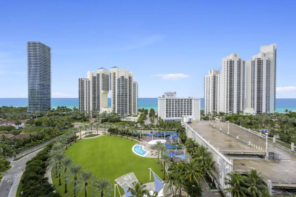 a view of a park in the middle of a city at Ocean View 15th floor Apartment Sunny Isles in Sunny Isles Beach