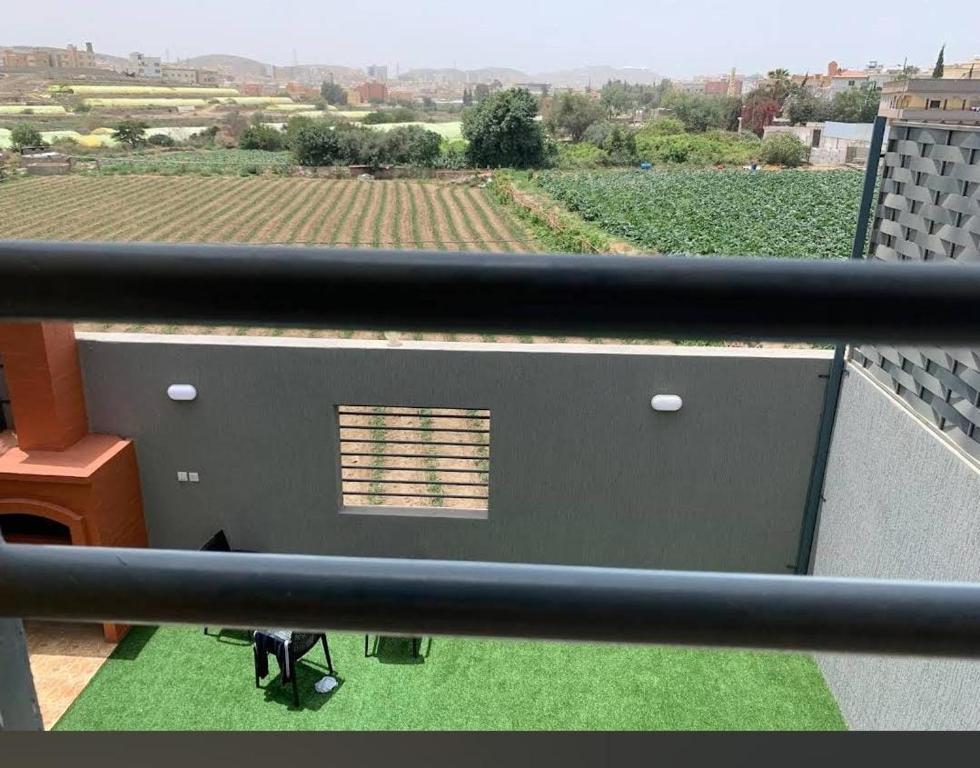 a balcony with a view of a field of crops at شاليهات الود in Abha