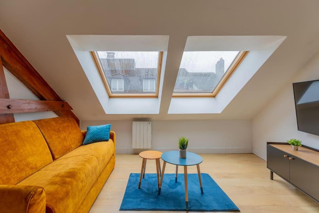 a living room with a couch and a table at Le petit Marcel - T3 / 6P - 60 m2 - hyper Centre ville Metz in Metz
