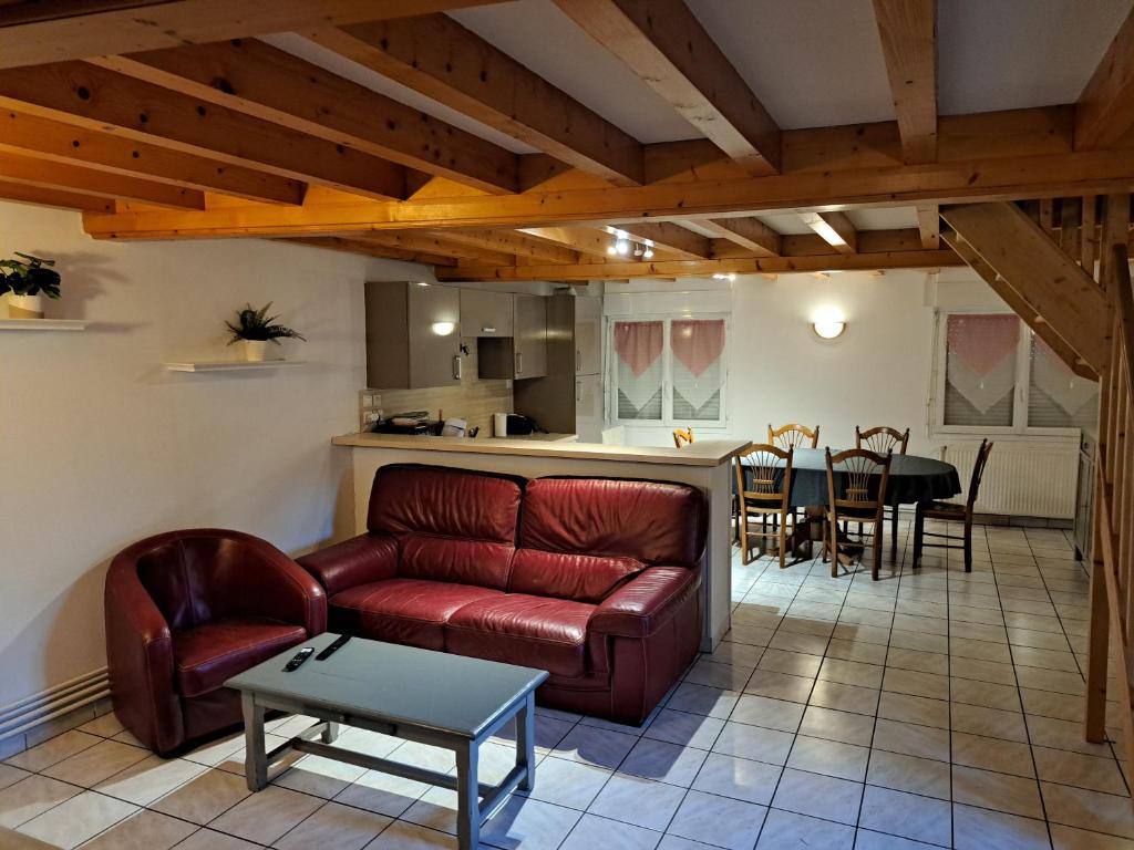 a living room with a couch and a table at La Boussole in Étretat