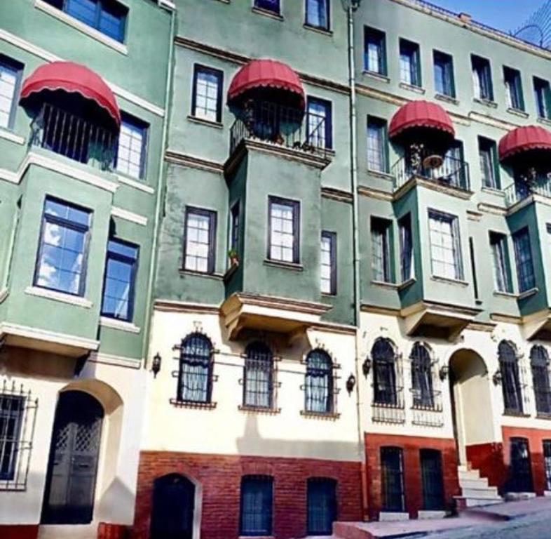a large building with red windows and balconies on it at The Red Tent Suite 88 in Istanbul