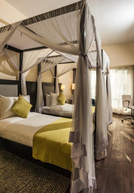 Postel nebo postele na pokoji v ubytování Acacia Premier Hotel