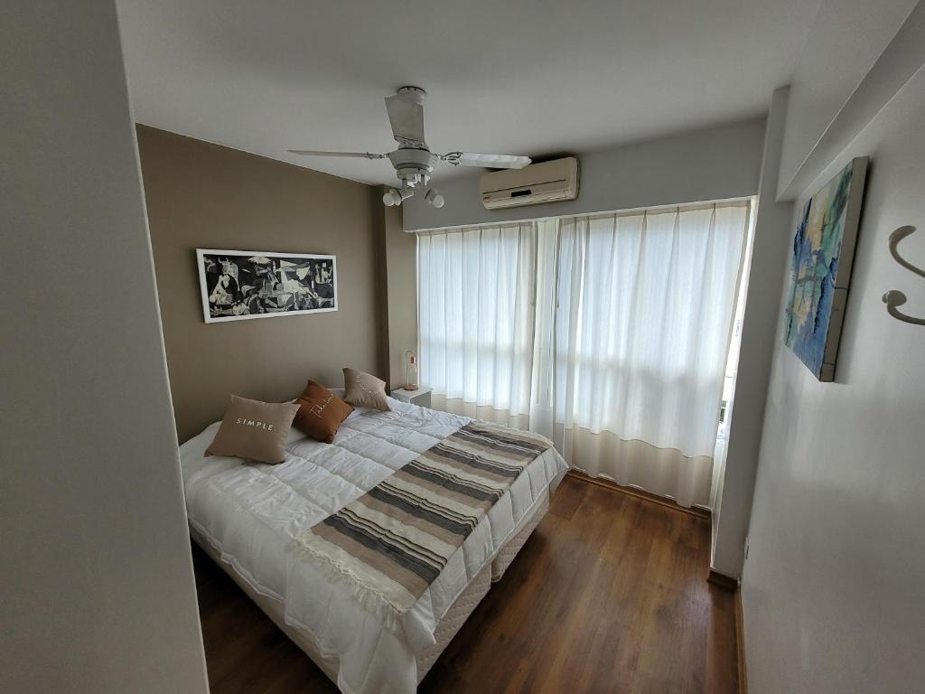 a bedroom with a bed and a large window at Pampa, Mayo home in Buenos Aires
