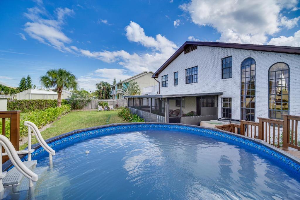 a swimming pool in front of a house at Moon Beach Manor with Private Pool and Hot Tub! in Cocoa Beach