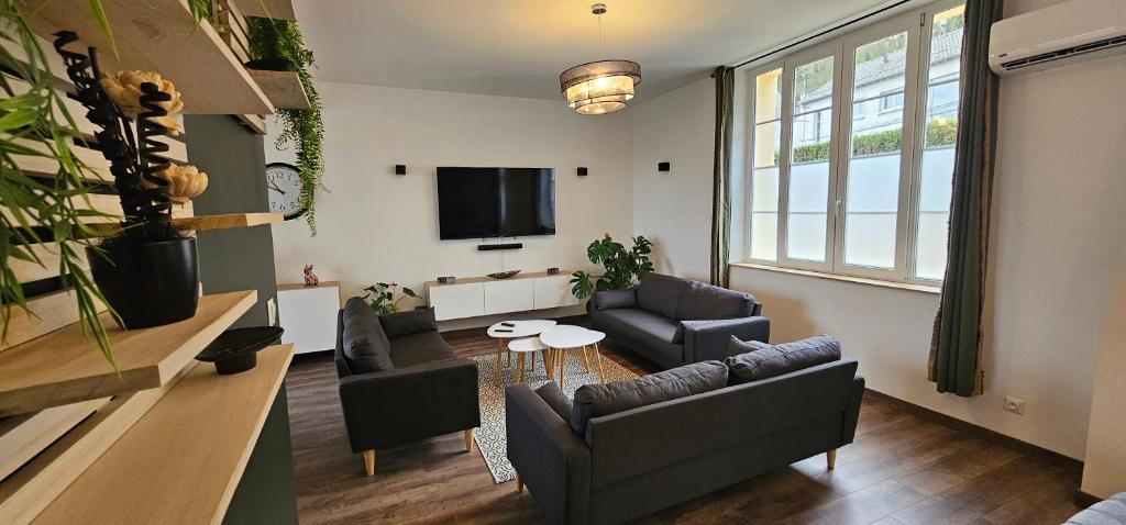 a living room with couches and a flat screen tv at Le Clos Maldier - Gîte de la Belle vue in Laon