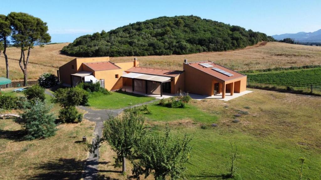 an aerial view of a house on a hill at Le CaRaMeLle di Baratti in Baratti