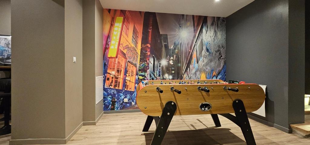 a wooden instrument in front of a wall with a painting at Le Clos Maldier - Gîte de la Belle vue in Laon