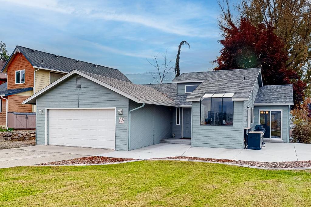 une maison avec un garage gris et une allée dans l'établissement Lake Cortez Cottage, 