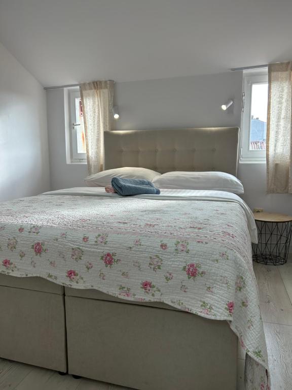 a bedroom with a bed with a floral bedspread at Apartments Oliva in Poreč