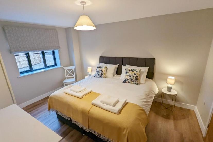 a bedroom with a large bed with two pillows on it at Meadow View Lodges in Bury Saint Edmunds
