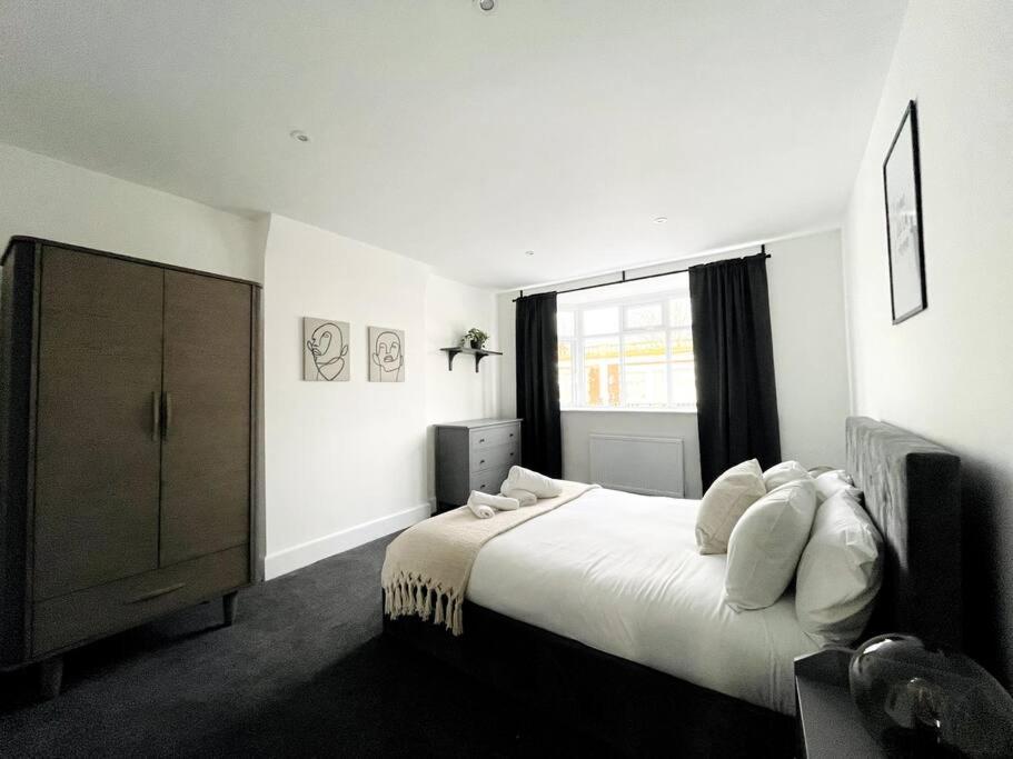 a bedroom with a large bed and a window at Solace in Bournemouth