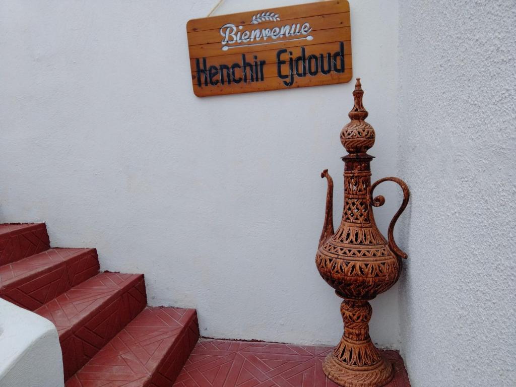 a vase sitting on the floor next to some stairs at Henchir ejdoud in Kairouan