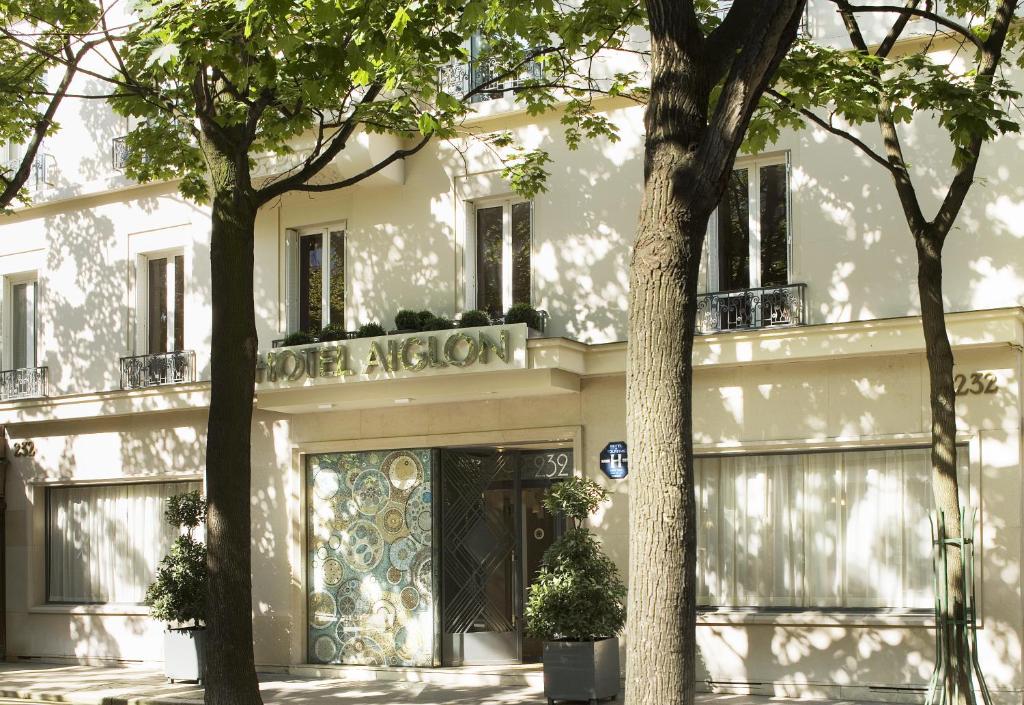 a building with a clock on the front of it at Hôtel Aiglon in Paris
