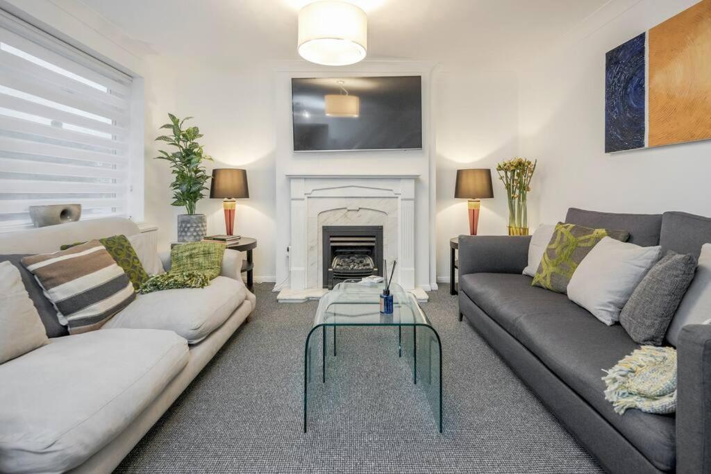 a living room with two couches and a fireplace at Newly renovated 5 Bed - Call 4 LONG STAY discount in Winkfield